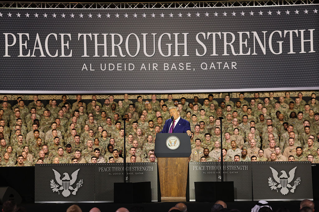 U.S. President Donald J. Trump speaks on stage during a tour of the Al Udeid Air Base on May 15, 2025, in Doha, Qatar. Trump is on the third day of his visit to the Gulf to underscore the strategic partnership between the United States and Qatar, focusing on regional security and economic collaboration.