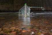 A shopping trolley abandoned in a river.