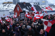 People bear Greenlandic flags as they gather in front of the U.S. consulate protest against U.S. President Donald Trump and his announced intent to acquire Greenland on January 17, 2026 in Nuuk, Greenland. Greenlandic, Danish and other European leaders are hoping they can still avert an intervention by the United States to forcefully acquire the island as U.S. President Donald Trump continues to insist the U.S. must have Greenland, suggesting even by military means if necessary.